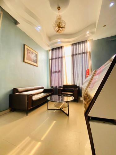 a living room with a couch and a table at BENJY palace hôtel in Matadi