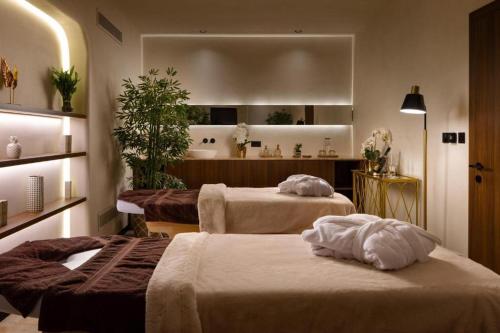 two beds in a hotel room with a bathroom at Mercury tower Elena K 24th panoramic view apartment in St Julian's