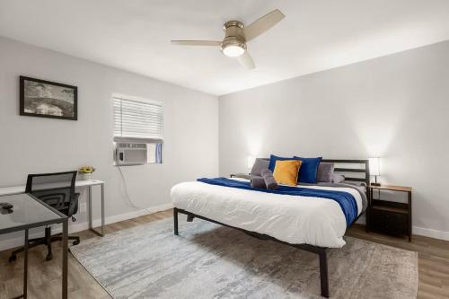 a bedroom with a bed with blue and yellow pillows at ATX Casa Tranquila in Austin