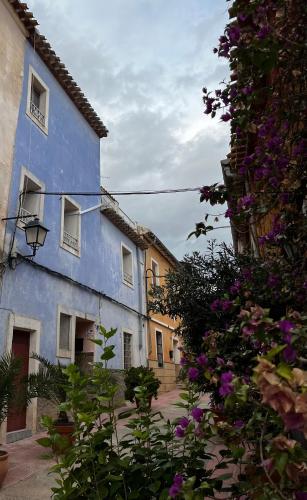 a group of buildings with purple flowers at La Casa Azul in Cehegín