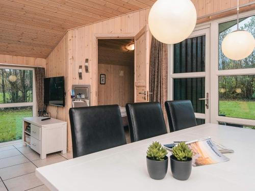 a dining room with a table and chairs at 6 person holiday home in Oksbøl-By Traum in Oksbøl
