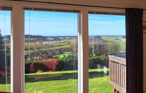 a window with a view of a yard at 3 Bedroom Stunning Home In Vanse in Borhaug
