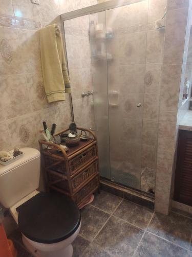 a bathroom with a shower and a toilet and a sink at Murillo in Montevideo