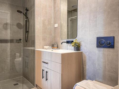 a bathroom with a sink and a shower at Mcity Morden 2BR with Free Parking in Clayton North