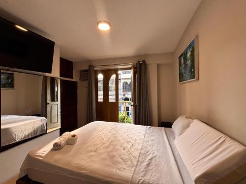 a hotel room with two beds and a window at Hotel Casa Luna in Iquitos