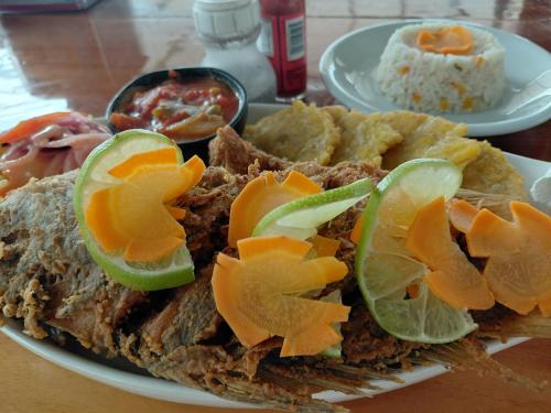 a plate of food with a sandwich and rice at El Remanso Hotel y Restaurante in Rivas
