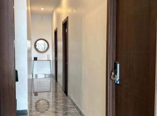 a hallway with a door and a mirror on the wall at TJ Brother Residences Cengkareng in Jakarta