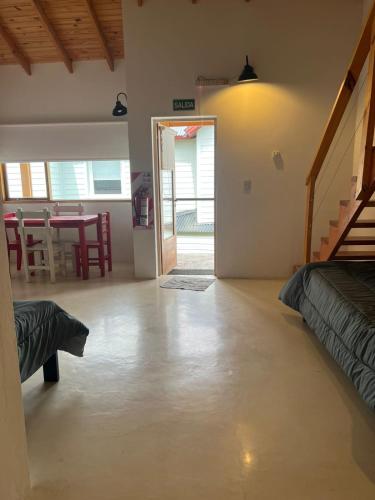 a living room with a bed and a dining room at Chalten Mountain Loft 6 in El Chalten
