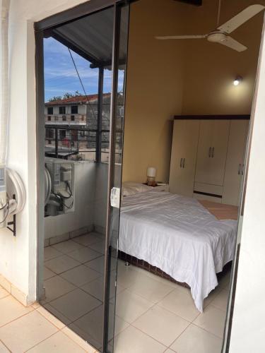 a bedroom with a bed on a balcony at Departamento in Fernando de la Mora