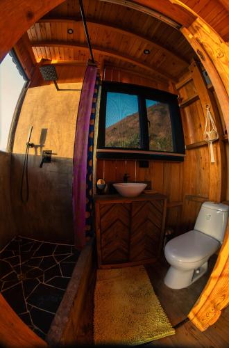 a bathroom with a toilet and a sink in a room at Lake Atitlán Panorama Chalets in San Marcos La Laguna