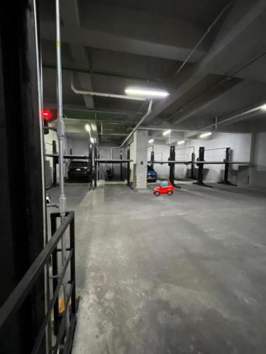 an empty parking garage with a red toy car in it at Departamento nuevo a 5 cuadras de Roma Norte in Mexico City