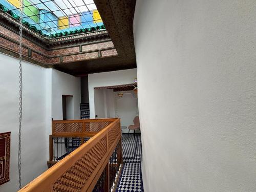 a hallway with a stained glass ceiling and stairs at M & S Guest House in Fès