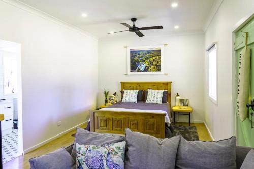 a bedroom with a bed and a couch at Donnelly's Keep Cottage 
