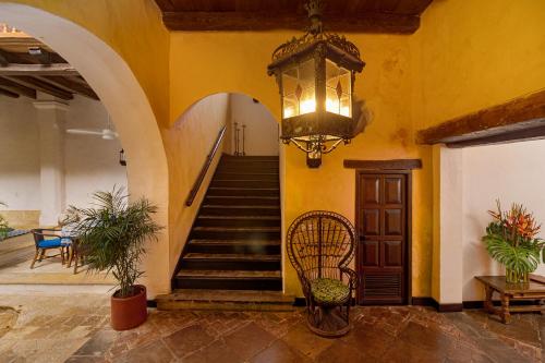 a staircase in a building with a chandelier at Casa Baloco in Cartagena de Indias