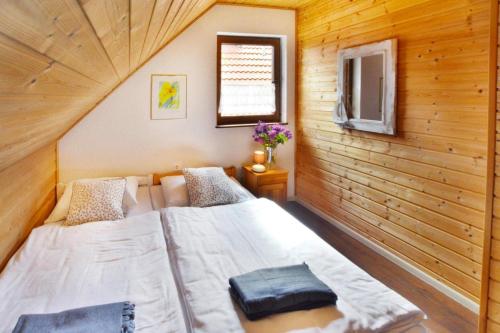 a bedroom with two beds in a wooden cabin at Comfortable holiday homes close to the beach in Bobolin