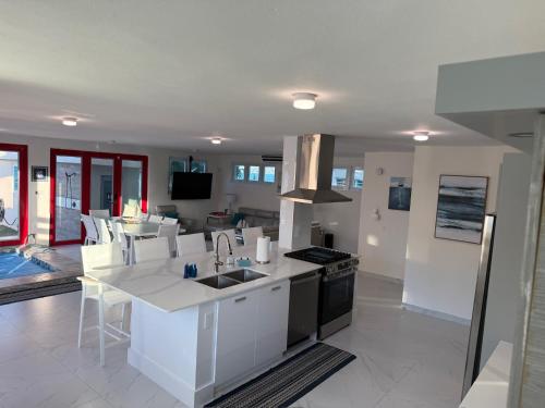 a kitchen with a sink and a stove top oven at Beachfront Spacious Luxury Villa Private Pool in Fortuna