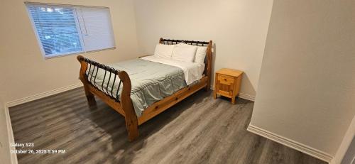 a small bedroom with a bed and a night stand at Lovely Rural Living in Cherry Valley