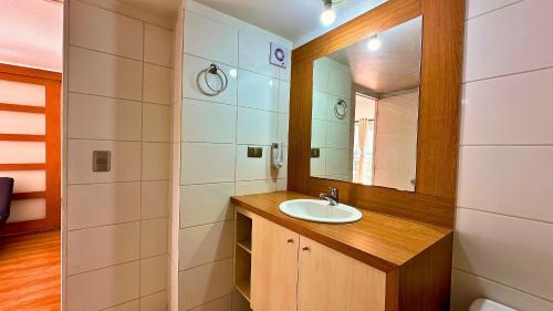 a bathroom with a sink and a mirror at Viña Sunset Escape in Viña del Mar