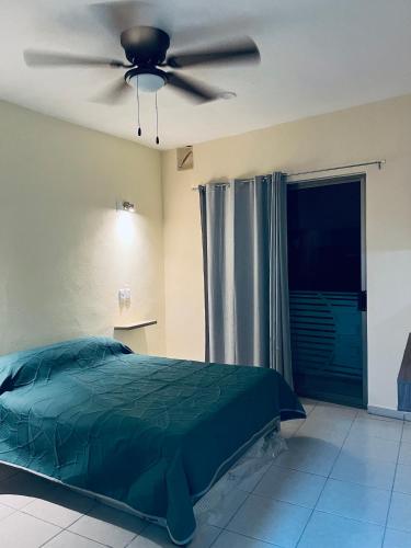 a bedroom with a bed and a ceiling fan at Herrera departamentos in Tepic