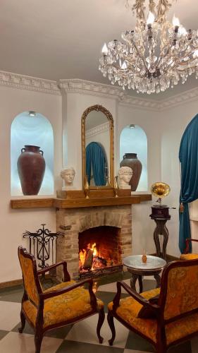 a living room with a fireplace and a chandelier at Otyak Plaza in Pʼarakʼar