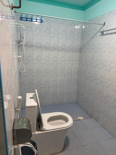 a bathroom with a toilet and a shower at Coconut Palm Dhidhoo in Ariyaddu
