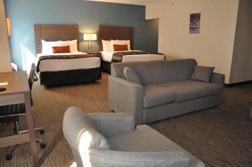 a large hotel room with two beds and a couch at Nobile Hotel Parkway at Celebration Orlando Very Close to Disney Theme Parks in Orlando