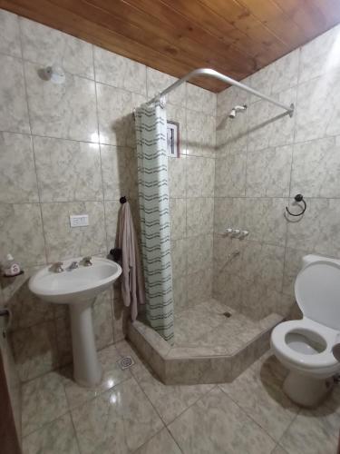 a bathroom with a sink and a toilet at El monito de Sanber in San Bernardo