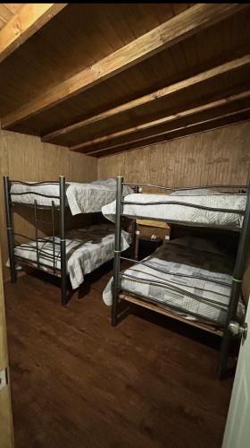 una habitación con tres literas en una habitación en Casa a Mano todo cercano, en Futrono