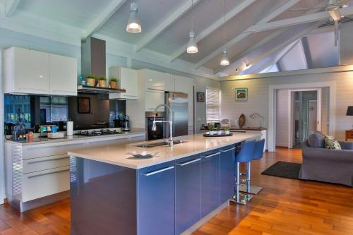 a kitchen with a large island in the middle at Tropical cocoon with 2 bedrooms in Papeete