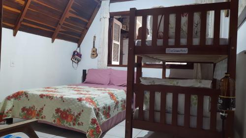 ein Schlafzimmer mit einem Etagenbett und einer Leiter in der Unterkunft Cabanna Hostel in Candelária