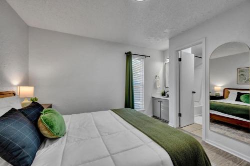 a bedroom with a large bed and a window at Near Boone Pickens Stadium - Stillwater Stay in Stillwater