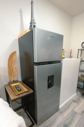 a large refrigerator in a room with a table at Departamento Nuevo in Tijuana
