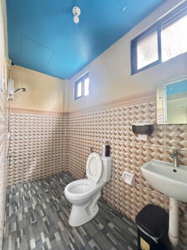 a bathroom with a toilet and a sink at Mariner's Pension House in Puerto Princesa City