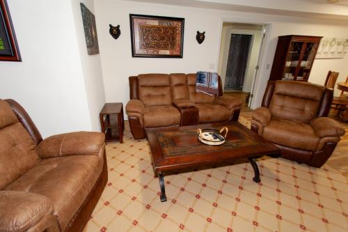 a living room with leather furniture and a coffee table at O'Brien's Sanctuary in Candler