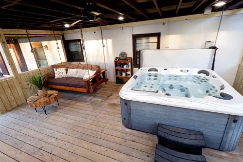 a large bath tub in a room with a couch at O'Brien's Sanctuary in Candler