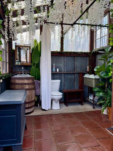an outdoor bathroom with a toilet and a sink at Glamping at Deer Camp in Dunlap