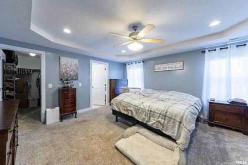 a bedroom with a bed and a ceiling fan at Spacious Home with Pool book your stay! in Marion