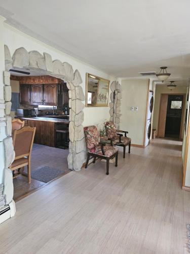 a living room with a stone fireplace in a house at Your comfortable stay in Colorado Springs in Colorado Springs