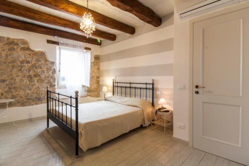 a bedroom with a bed and a window and a door at Aia Antica in Monte San Biagio