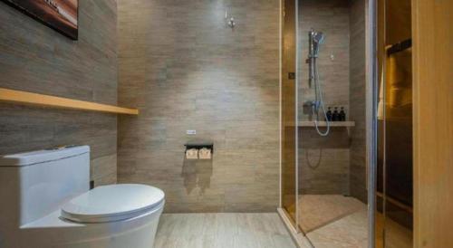 a bathroom with a toilet and a shower at Atour Hotel Nanchang Longding Chadu East Jiefang Road in Nanchang