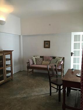 a living room with a couch and a table at Villa Helena in Puducherry