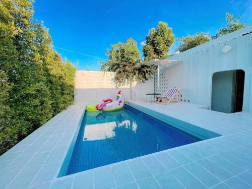 a swimming pool with a toy in a house at 7 Class Pool Villa in Chachoengsao