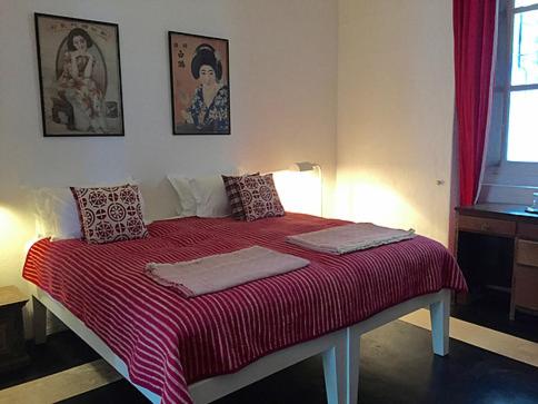 a bed with two pillows on it in a room at Villa Helena in Puducherry