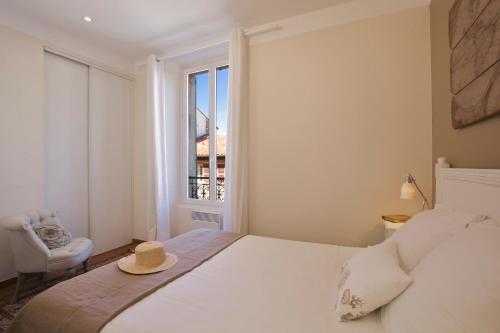 a bedroom with a bed with a hat on it at 15 Cours Massena in Antibes