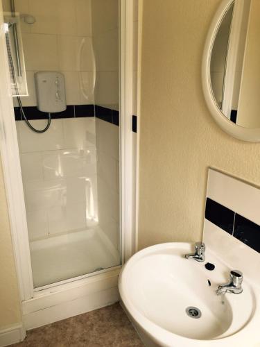 a bathroom with a sink and a shower at The Tudor House Hotel in Nottingham