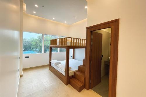 a bedroom with a bunk bed and a mirror at Konnect Inn-New Delhi Railway Station in New Delhi