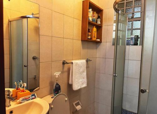 a bathroom with a shower and a toilet and a sink at Majestic Two-bedroom House in a prime location in Nairobi