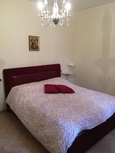 a bedroom with a bed with a red pillow on it at Alle Porte di Assisi in Assisi