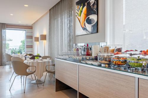a restaurant with a counter with food on it at Hotel Eden in Sirmione