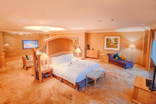 a bedroom with a large bed and a living room at Regency Hotel in Ma Yu